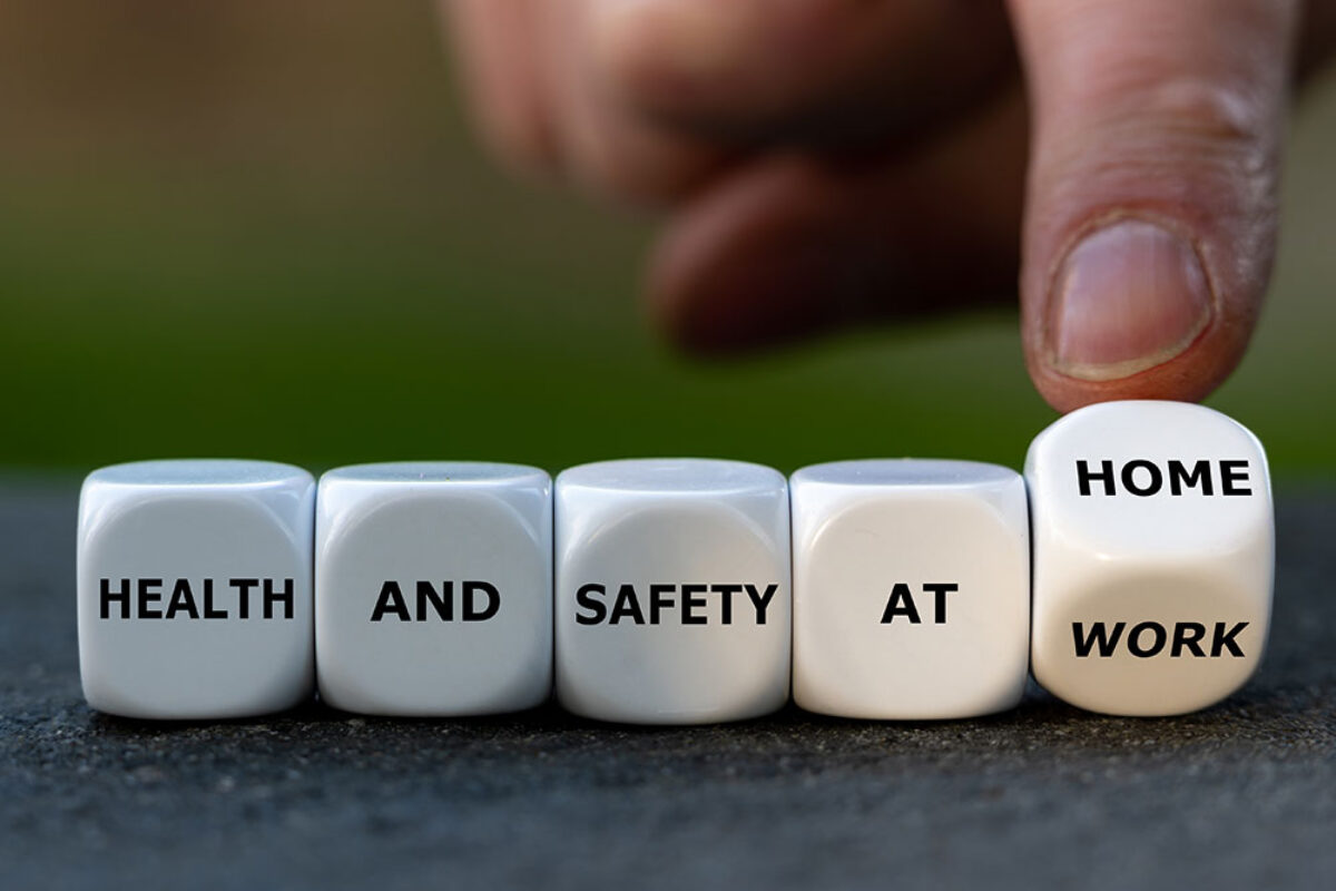 Image of dice with a hand pointing to dice. Words on dice read Health and safety at work