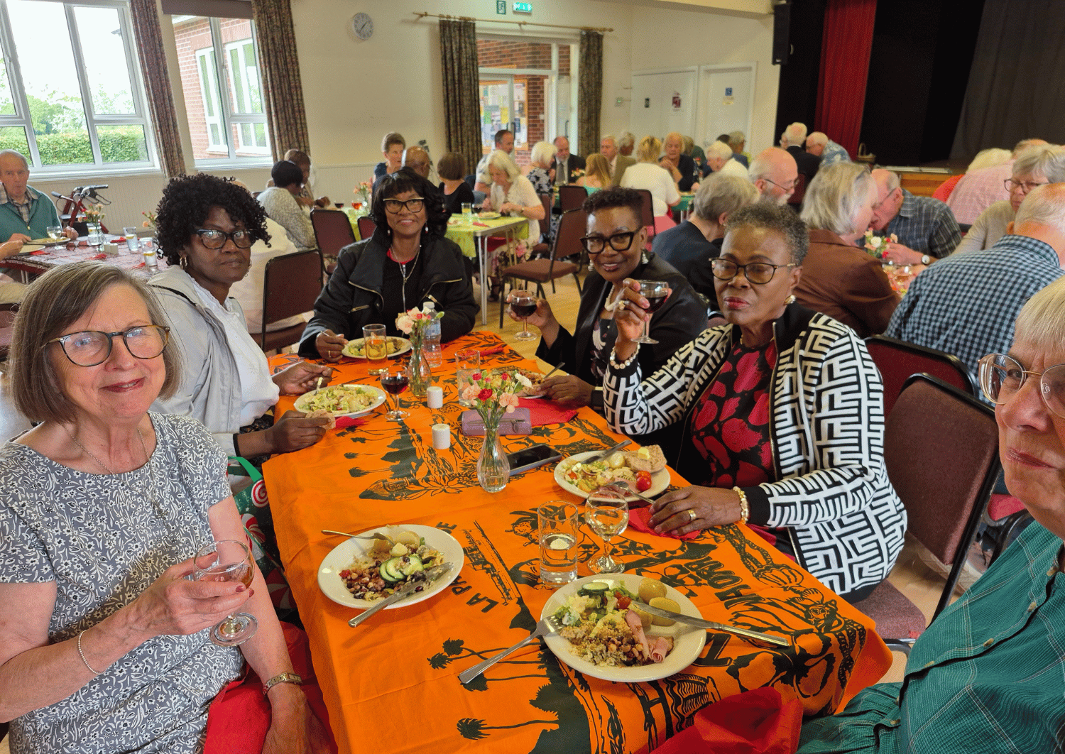 group of women sat around table enjoying fellowing and food at St James Colwall