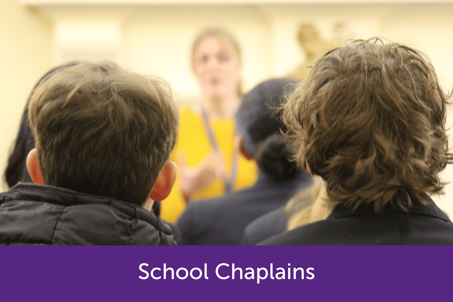 School children listening to a school chaplain