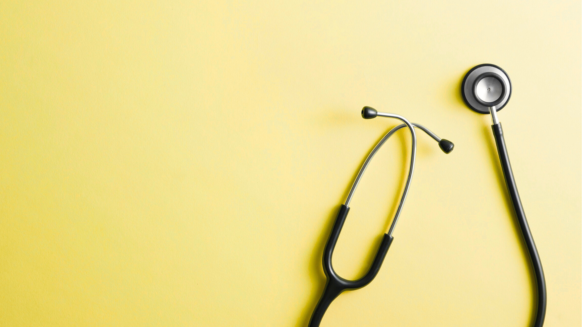 Stethoscope on yellow background