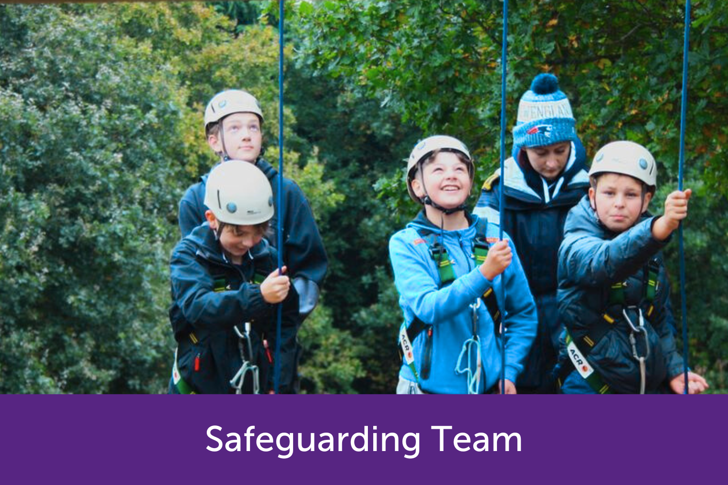 Children about to go down a climbing wall