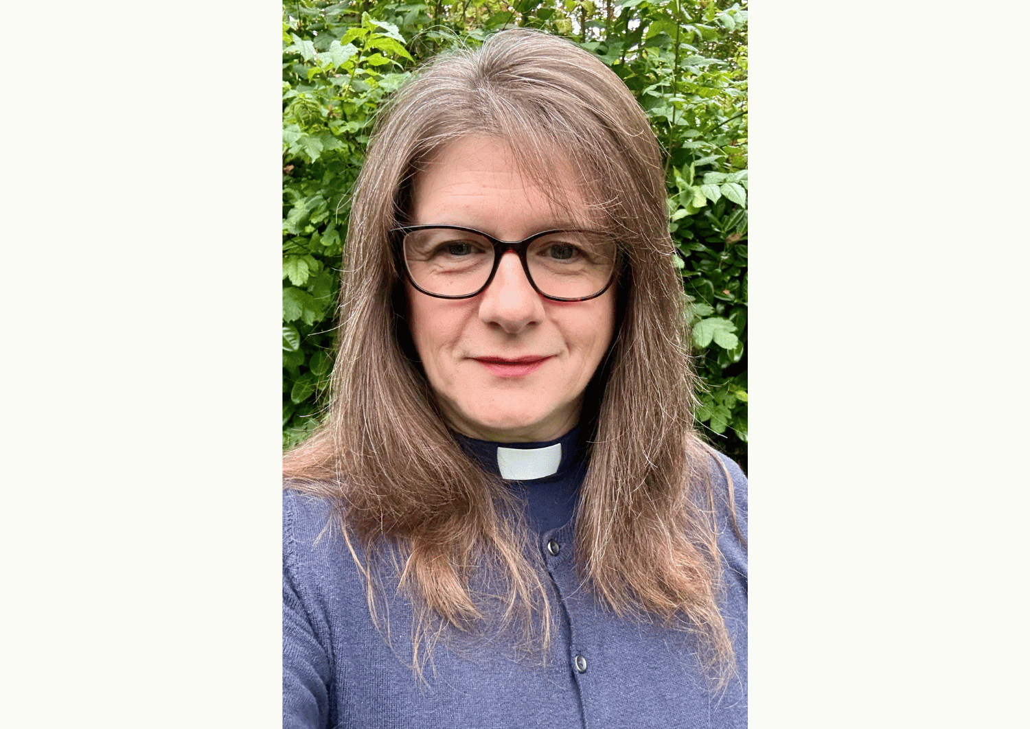 Fiona Gibson, Archdeacon of Ludlow, shown standing in front of green hedge