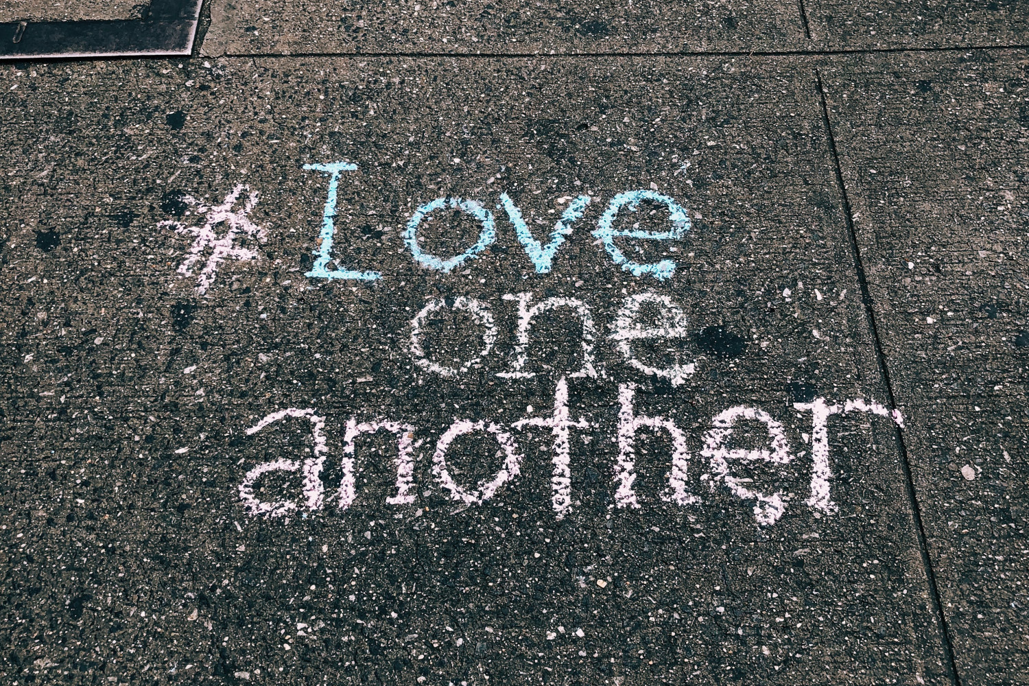 Image of Pavement with chalf sign writing saying love one another