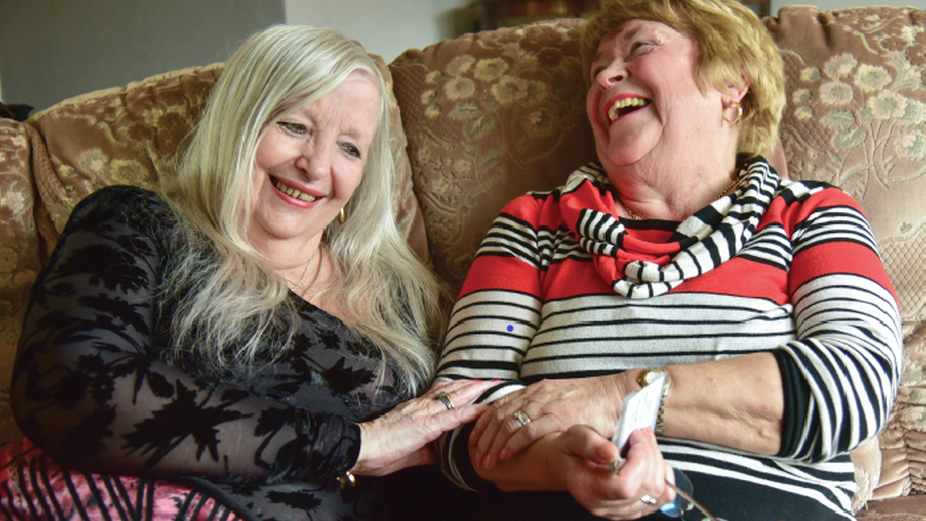 Elizabeth Gervais-Golland (left) shares happy memories with Co Co volunteer Nancy Hemmings (right)