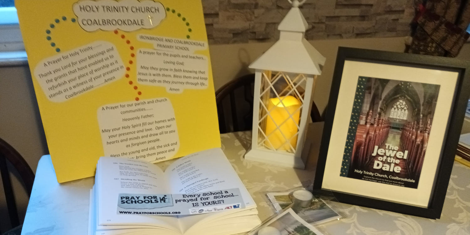 Prayer table with candle, prayers and photos from Coalbrokdale Church