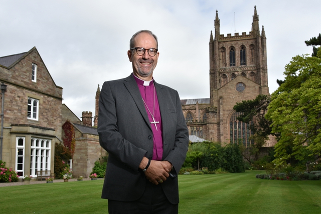 Bishop of Hereford Rt Revd Richard Jackson with Hereford cathedral in background